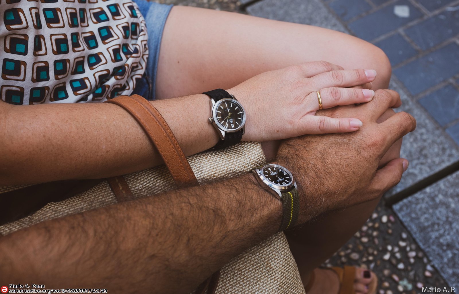 On-wrist photo of two black-dial Rolex Explorer-style watches (3-6-9 numerals) on fabric straps